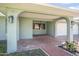 Inviting covered front porch with brick pavers and arched entryways at 44 Sandra Dr, Ormond Beach, FL 32176