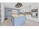 Spacious kitchen features a large center island, white cabinets, stainless steel appliances, and stylish tile backsplash at 44 Sandra Dr, Ormond Beach, FL 32176