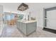 Open kitchen with center island cooktop, white cabinets, tile floors, and adjoined dining area at 44 Sandra Dr, Ormond Beach, FL 32176