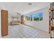 Sunlit living room boasts tile floors, large windows, and built-in bookshelves at 44 Sandra Dr, Ormond Beach, FL 32176