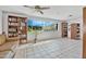 Open living room with tile floor, large windows, and built-in bookshelves at 44 Sandra Dr, Ormond Beach, FL 32176