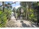 Inviting park entrance with a wooden path amidst lush greenery and shade at 44 Sandra Dr, Ormond Beach, FL 32176