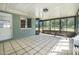 Tiled sunroom with lots of windows bringing in natural light at 44 Sandra Dr, Ormond Beach, FL 32176