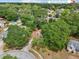 Aerial view of a lush, tree-lined neighborhood showing a home with a brown roof at 440 Champagne Cir, Port Orange, FL 32127