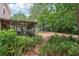 View of the backyard with lush ferns and patio, creating a serene outdoor space at 440 Champagne Cir, Port Orange, FL 32127