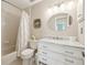 Bathroom featuring neutral tones, white cabinets and a tub/shower combo at 440 Champagne Cir, Port Orange, FL 32127
