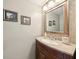 Powder room with a tile backsplash, framed mirror and a single vanity at 440 Champagne Cir, Port Orange, FL 32127