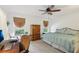 Bedroom features a ceiling fan, two windows and a wardrobe cabinet at 440 Champagne Cir, Port Orange, FL 32127
