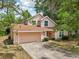 Charming two-story home features a well-maintained lawn and a two-car garage at 440 Champagne Cir, Port Orange, FL 32127