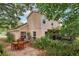 Exterior view of the home with covered patio, wooden patio set and landscaping at 440 Champagne Cir, Port Orange, FL 32127