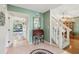 Inviting foyer with tile flooring and staircase, leading into the dining and living areas at 440 Champagne Cir, Port Orange, FL 32127