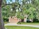Charming two-story home with a two-car garage framed by mature trees draped with Spanish moss at 440 Champagne Cir, Port Orange, FL 32127