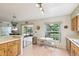 Bright kitchen with tile floors, a breakfast nook, and access to the screened patio at 440 Champagne Cir, Port Orange, FL 32127