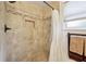 Shower featuring neutral tile with built-in niche and window for natural light at 440 Champagne Cir, Port Orange, FL 32127