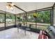 View of the sun room with an outdoor grill and hanging plants, overlooking the backyard at 440 Champagne Cir, Port Orange, FL 32127