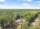Beautiful aerial view of a modern home nestled amidst lush green trees and landscaping at 5620 Ridgewood Ave, De Leon Springs, FL 32130