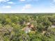 Scenic aerial perspective shows the home surrounded by serene nature and mature trees at 5620 Ridgewood Ave, De Leon Springs, FL 32130