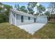 Attractive siding with patio surrounded by greenery, offering privacy at 5620 Ridgewood Ave, De Leon Springs, FL 32130