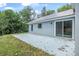 Charming home backyard features a patio and siding, surrounded by lush greenery at 5620 Ridgewood Ave, De Leon Springs, FL 32130