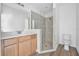A modern bathroom featuring a glass-enclosed shower and wood vanity at 5620 Ridgewood Ave, De Leon Springs, FL 32130