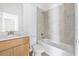 Bright bathroom features light wood cabinets, a combo tub and shower, and modern fixtures at 5620 Ridgewood Ave, De Leon Springs, FL 32130