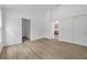 Bright bedroom features modern flooring, white trim, a closet, and three doorways creating an open layout at 5620 Ridgewood Ave, De Leon Springs, FL 32130