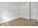 Empty bedroom features modern flooring, white trim, a closet, and bright lighting creating a versatile space at 5620 Ridgewood Ave, De Leon Springs, FL 32130