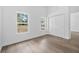 Bright room with wood-look floors, white trim, two windows, and a closet, creating a cozy and inviting space at 5620 Ridgewood Ave, De Leon Springs, FL 32130