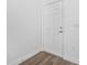Bright entryway featuring a white door and matching trim and wood-look floors at 5620 Ridgewood Ave, De Leon Springs, FL 32130