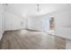 Open-concept living room with sliding glass doors and luxury vinyl floors at 5620 Ridgewood Ave, De Leon Springs, FL 32130