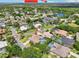 Expansive aerial view of a residential neighborhood with mature trees, and pools with glimpses of the beach at 6 Talaquah Blvd, Ormond Beach, FL 32174