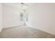 Bright bedroom with neutral walls, carpet, ceiling fan, and plantation shutters at 6 Talaquah Blvd, Ormond Beach, FL 32174
