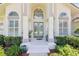 Charming front entrance with double doors, arched windows and well-maintained landscaping at 6 Talaquah Blvd, Ormond Beach, FL 32174
