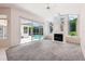 Spacious living room with fireplace and sliding glass doors leading to an enclosed pool area at 6 Talaquah Blvd, Ormond Beach, FL 32174