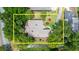 Aerial view of a single-story home surrounded by mature landscaping and adjacent to a natural waterway at 912 Fruitwood Pl, Port Orange, FL 32127