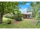Large backyard with mature trees, lush grass, and a view of the home at 912 Fruitwood Pl, Port Orange, FL 32127
