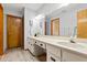 Bathroom featuring a vanity, sink, mirror, and wood door at 912 Fruitwood Pl, Port Orange, FL 32127