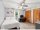 Bright bedroom featuring a bed, desk, closet, ceiling fan, and dinosaur-themed decor at 912 Fruitwood Pl, Port Orange, FL 32127