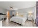 Bright main bedroom with white bedding, a ceiling fan, and neutral walls at 912 Fruitwood Pl, Port Orange, FL 32127