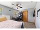 Cozy bedroom featuring a modern bed frame, a desk, and a ceiling fan at 912 Fruitwood Pl, Port Orange, FL 32127
