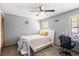 Comfortable bedroom with a modern bed frame, a desk, and a ceiling fan at 912 Fruitwood Pl, Port Orange, FL 32127