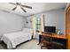 Bright bedroom featuring a bed, desk, closet, ceiling fan, and dinosaur-themed decor at 912 Fruitwood Pl, Port Orange, FL 32127