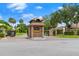 The Hunt Club's stately brick entrance features a decorative gatehouse, inviting residents and guests into the community at 912 Fruitwood Pl, Port Orange, FL 32127