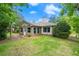 Charming single-Gathering home showcasing lush green lawn, mature trees, and neutral exterior paint under a sunny sky at 912 Fruitwood Pl, Port Orange, FL 32127