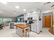 Bright kitchen featuring an island, white cabinetry, and stainless steel appliances at 912 Fruitwood Pl, Port Orange, FL 32127