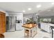 Bright kitchen featuring stainless steel appliances, white cabinetry, a large center island, and view to the dining room at 912 Fruitwood Pl, Port Orange, FL 32127
