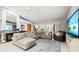 Open living room with a fireplace, comfortable sofa, and view of the lanai at 912 Fruitwood Pl, Port Orange, FL 32127