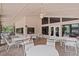 Covered patio area with multiple tables and chairs for a relaxing outdoor experience at 912 Fruitwood Pl, Port Orange, FL 32127