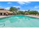 Community swimming pool with lounge chairs, cabanas, and meticulously maintained landscaping, creating a resort-like atmosphere at 912 Fruitwood Pl, Port Orange, FL 32127