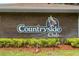Countryside Club sign displayed on a brick wall. Lush foliage adds a touch of nature at 912 Fruitwood Pl, Port Orange, FL 32127
